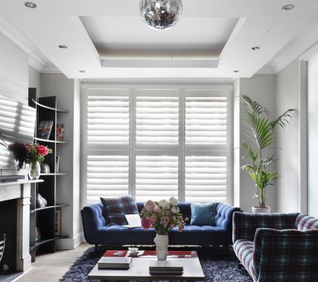 A living room with two sofas, a coffee table, and a disco ball hanging from the ceiling