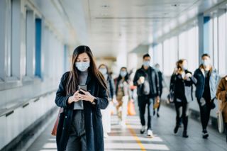 Face coverings exemptions: A woman walking down a subway in a face mask