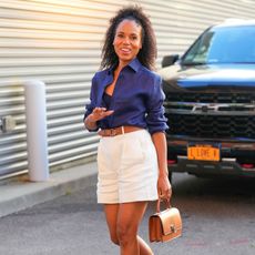 Kerry Washington wears a blue button-down shirt and white shorts at the U.S. Open 2024