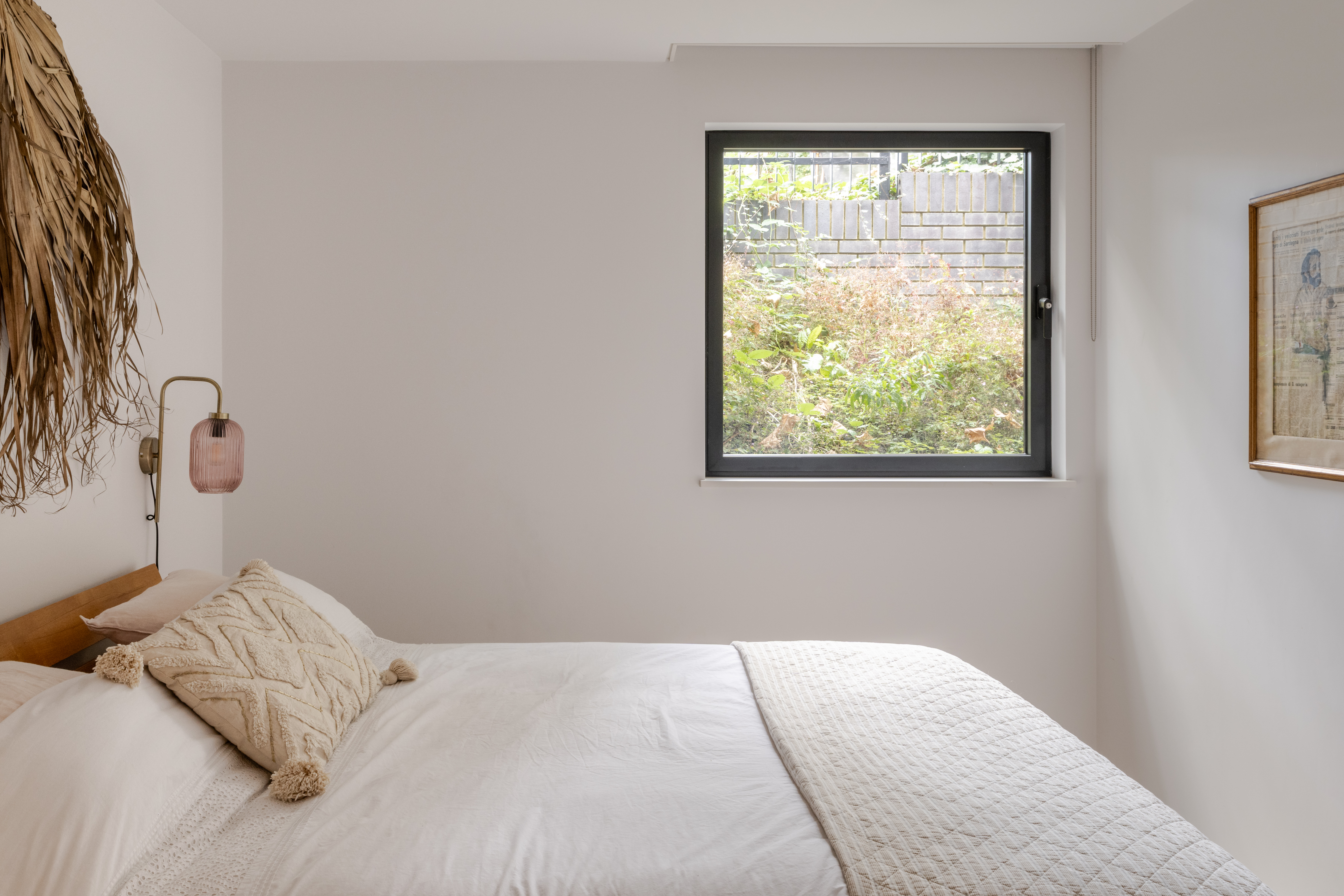 arbour house, a low, one storey home in a back year among trees, but with a distinctive angular roof