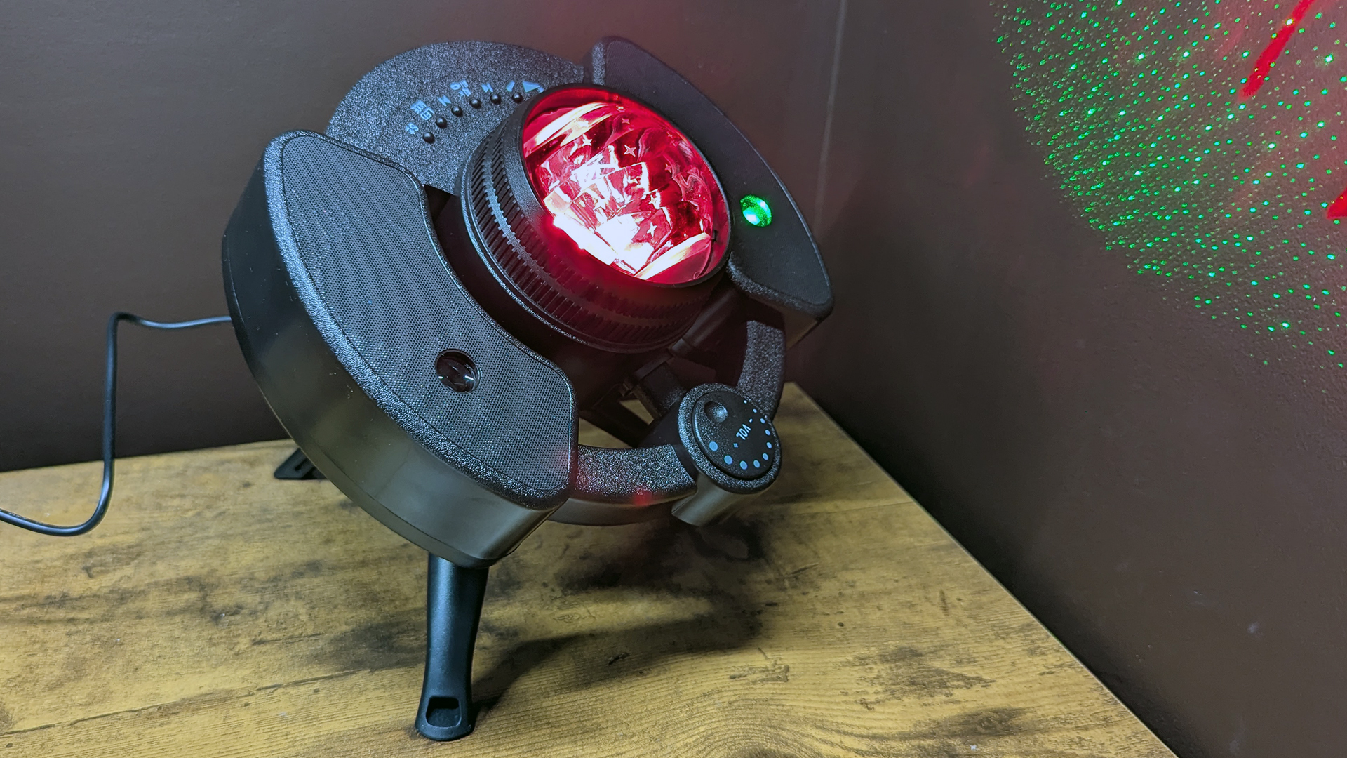 YgiTK Northern Galaxy Lights Projector during Review, on a wooden table against a dark coloured wall