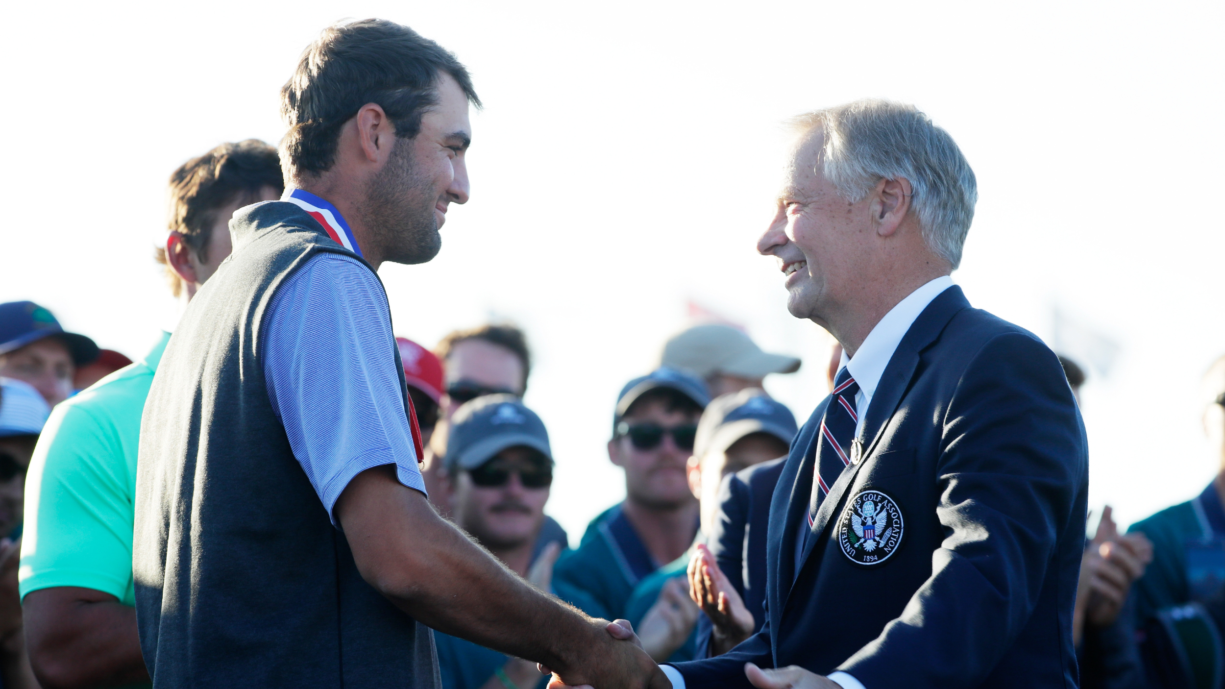 Scottie Scheffler is handed his US Open low amateur medal