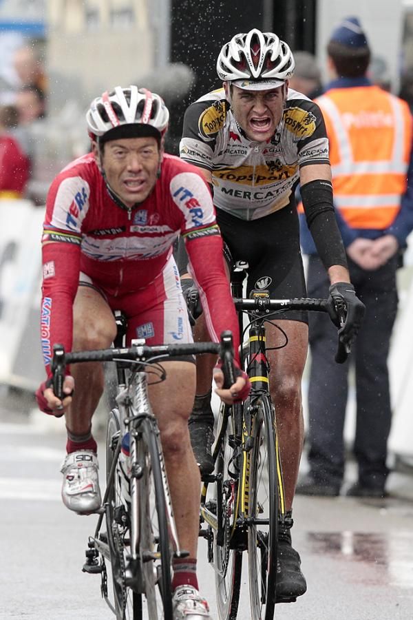 Oscar Freire (Katusha) sprints to second in the rain ahead of Pierre Serry (Topsport Vlaanderen)