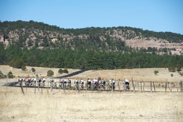 The cat 4/5 pack crosses an open field just past the Continental Divide.