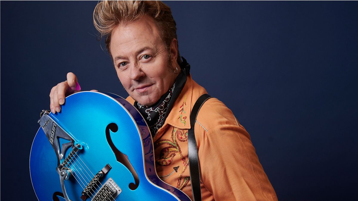 Brian Setzer poses with Gretsch guitar