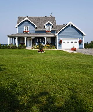 large blue house with big front yard