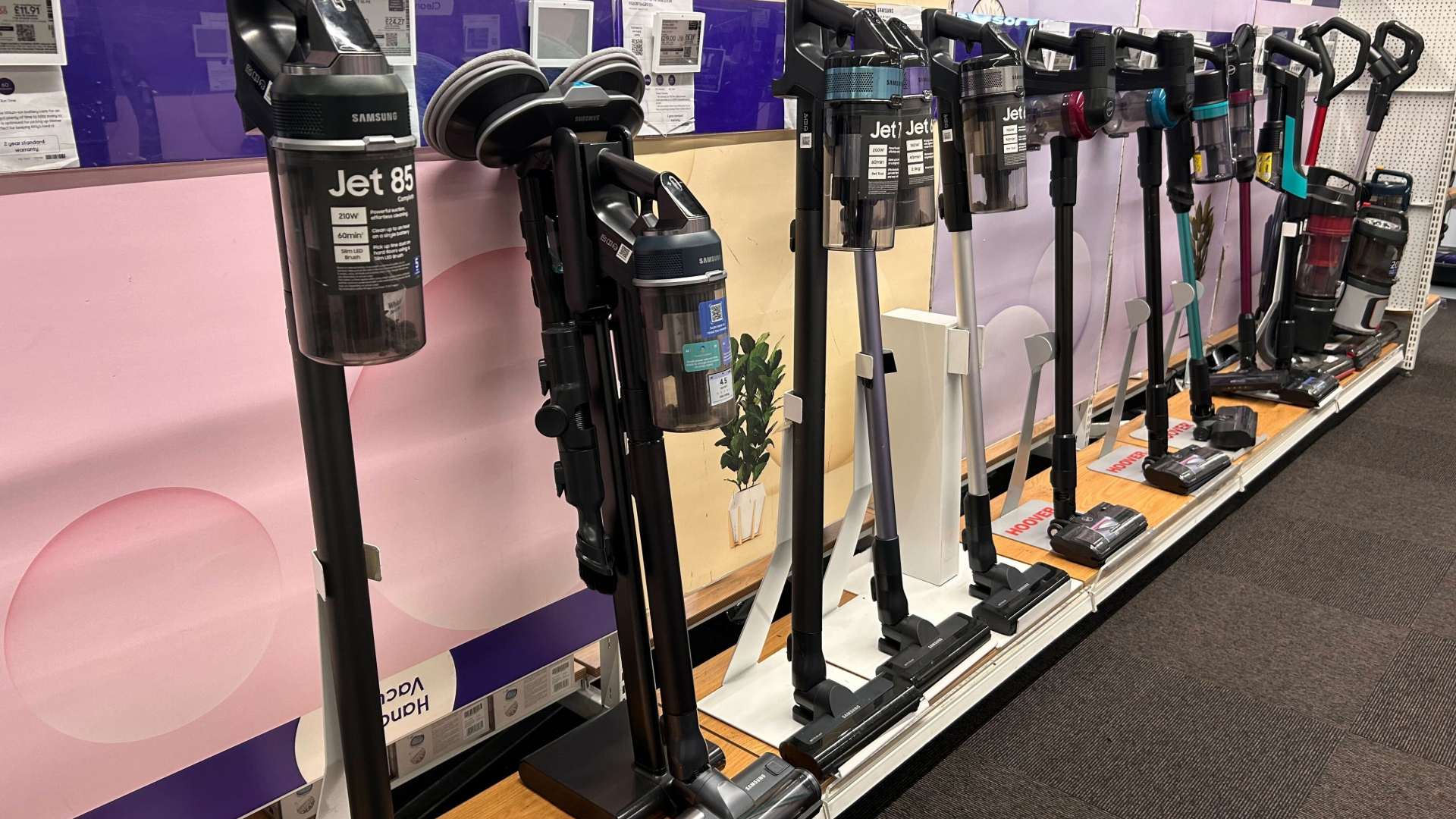 A line of vacuum cleaners in a shop