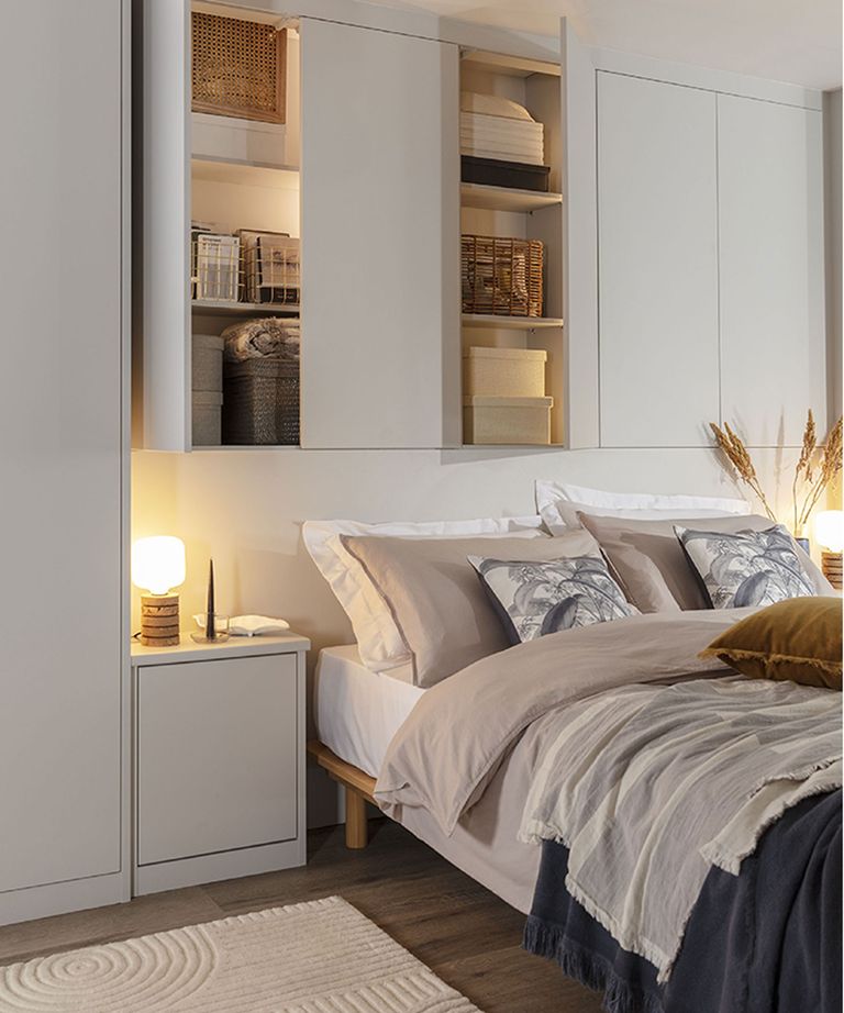 neutral bedroom with overbed shelving and cupboards