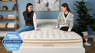 Two mattress testers sat on the Saatva Classic mattress in a well-lit bedroom