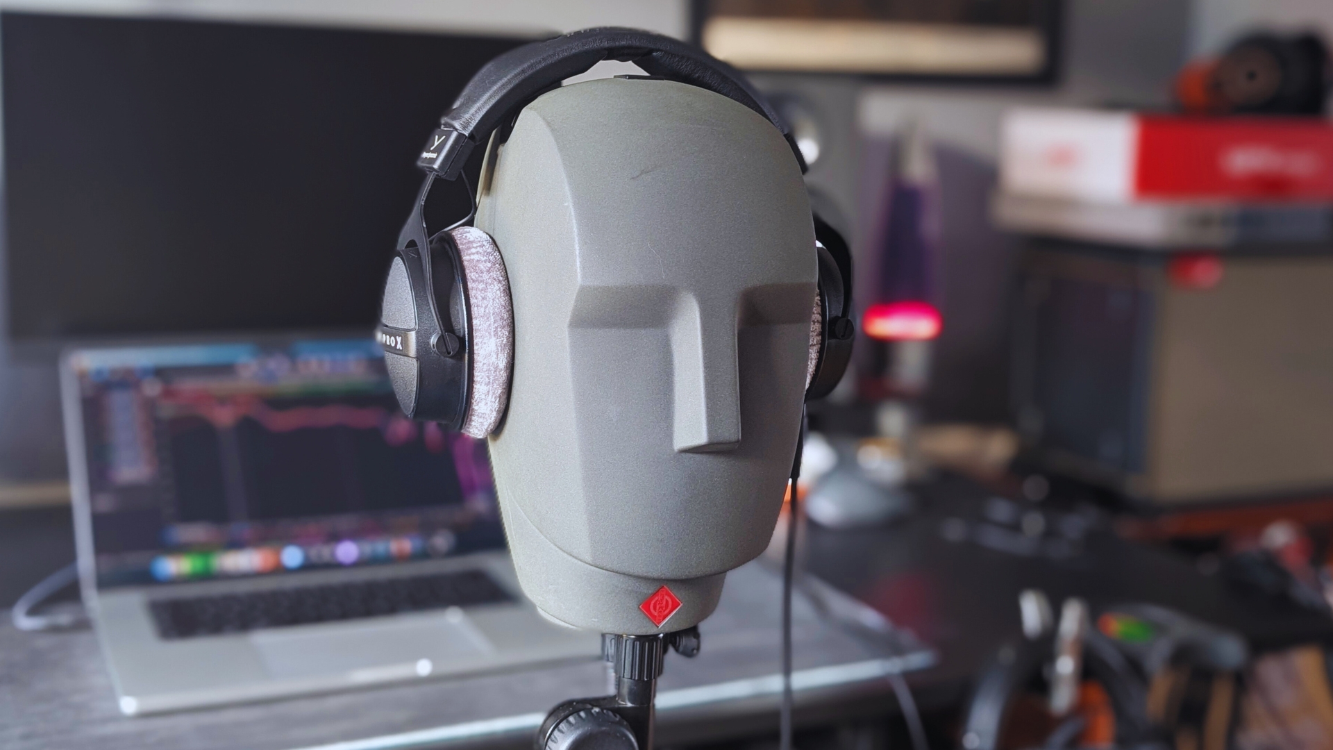 A pair of Beyerdynamic DT 770 Pro X studio headphones on a Neumann KU 100 dummy head