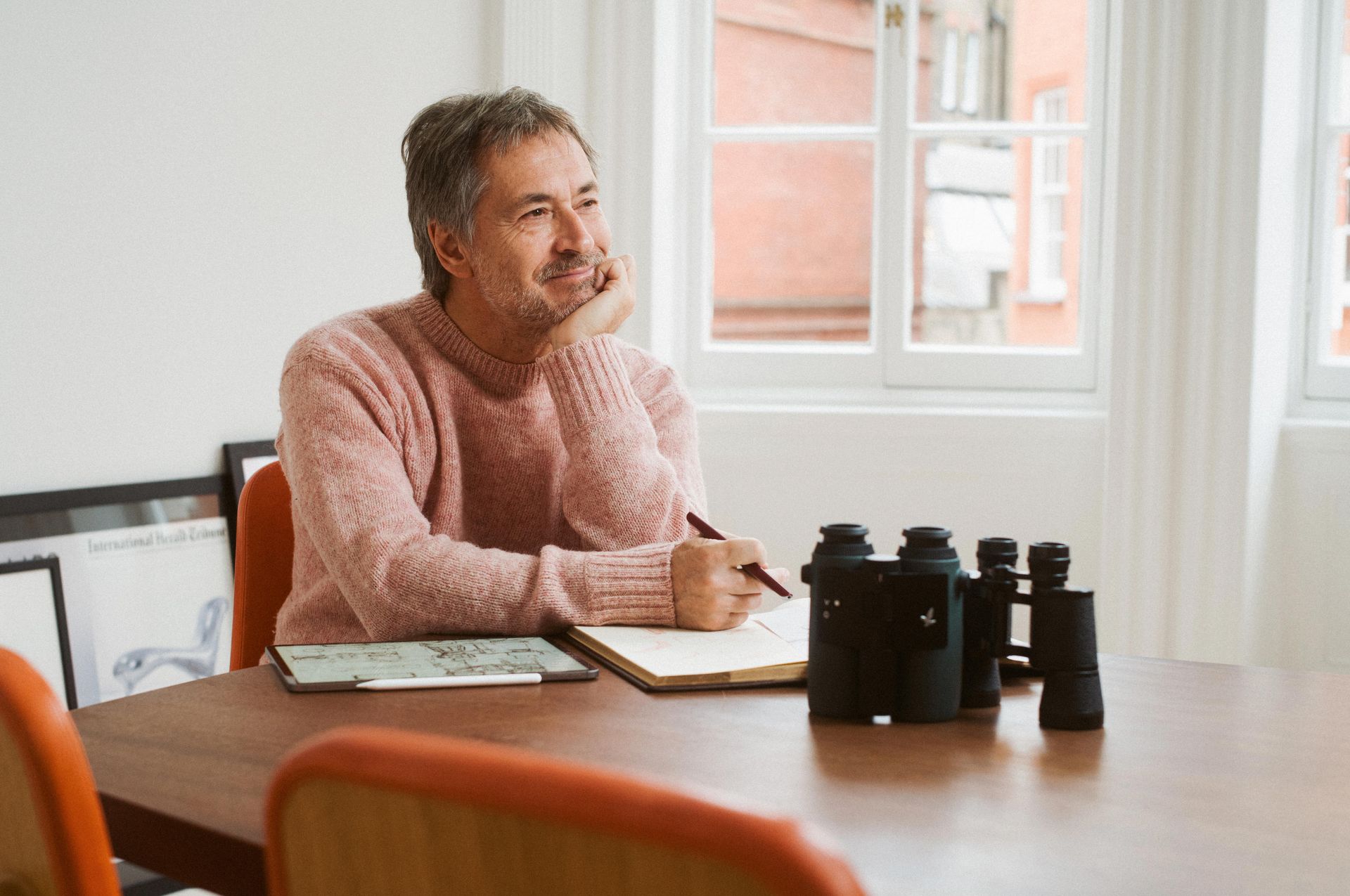 Marc Newson with binoculars on table
