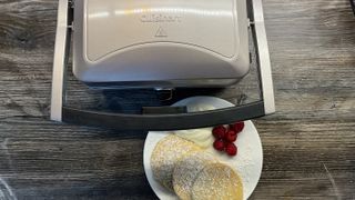 pancakes with berries and yogurt next to cuisinart 2 in 1 waffle and pancake maker