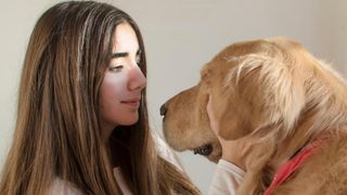 girl looking at her dog