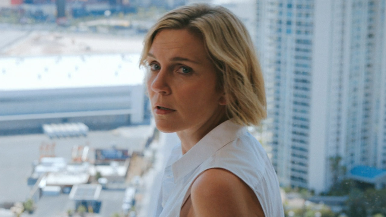 Carol looking back at an off-camera Koumba in Pluribus episode 6