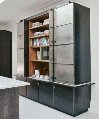 Grey kitchen with metallic fronted cabinet