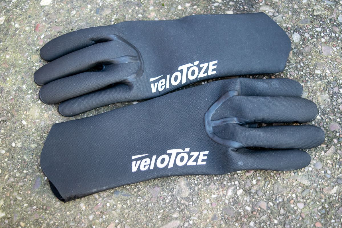 Black Velotoze neoprene gloves on some concrete
