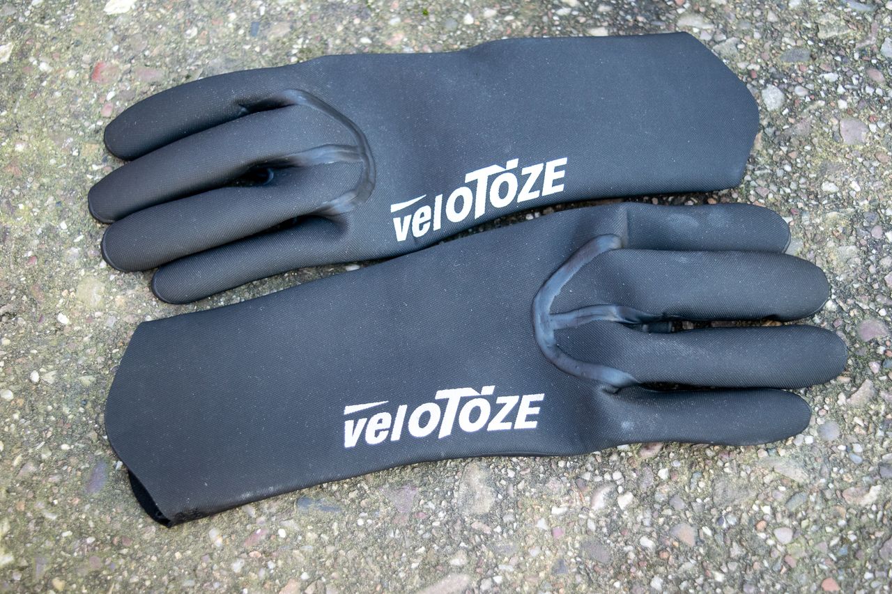 Black Velotoze neoprene gloves on some concrete