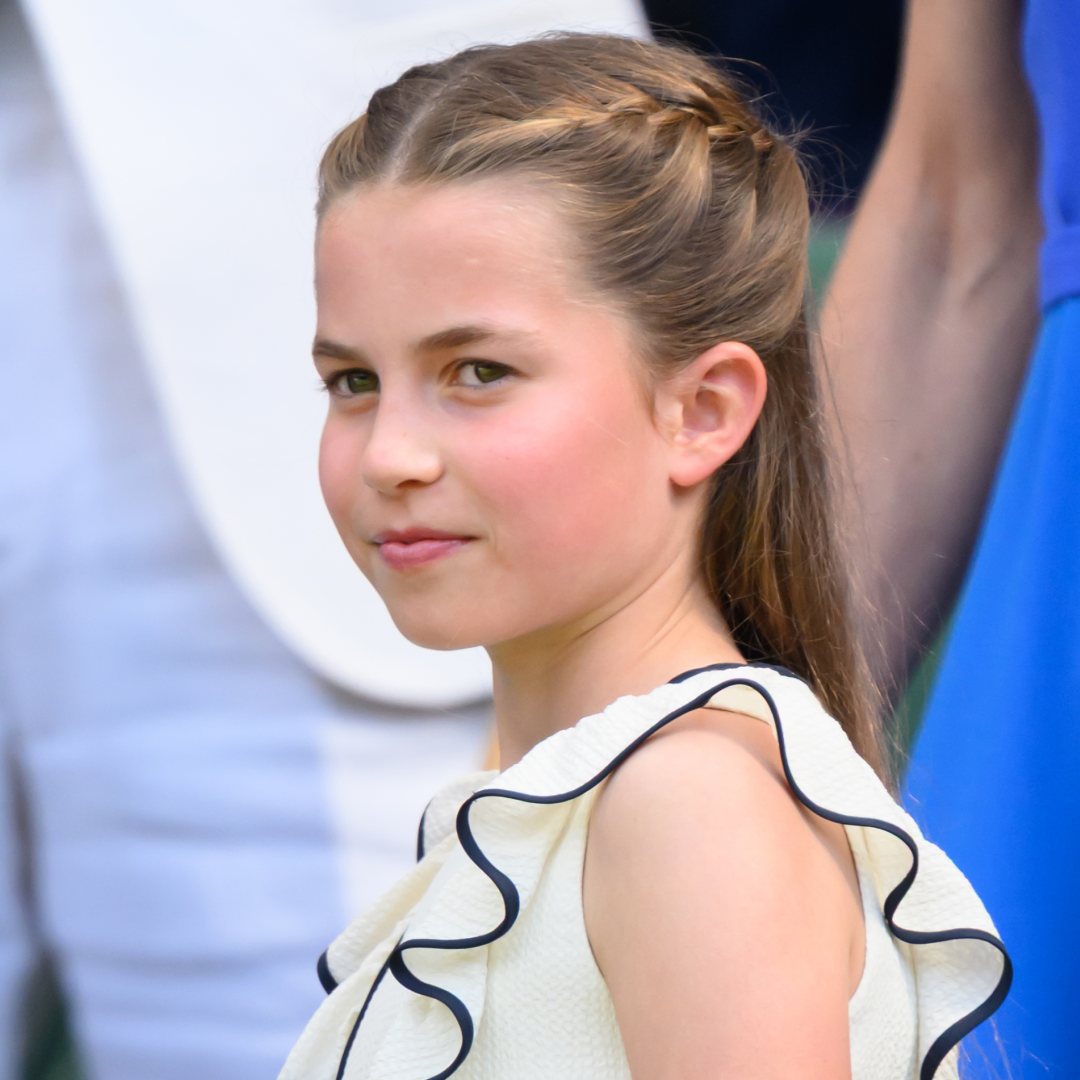 Princess Charlotte has braided hair and wears a white dress