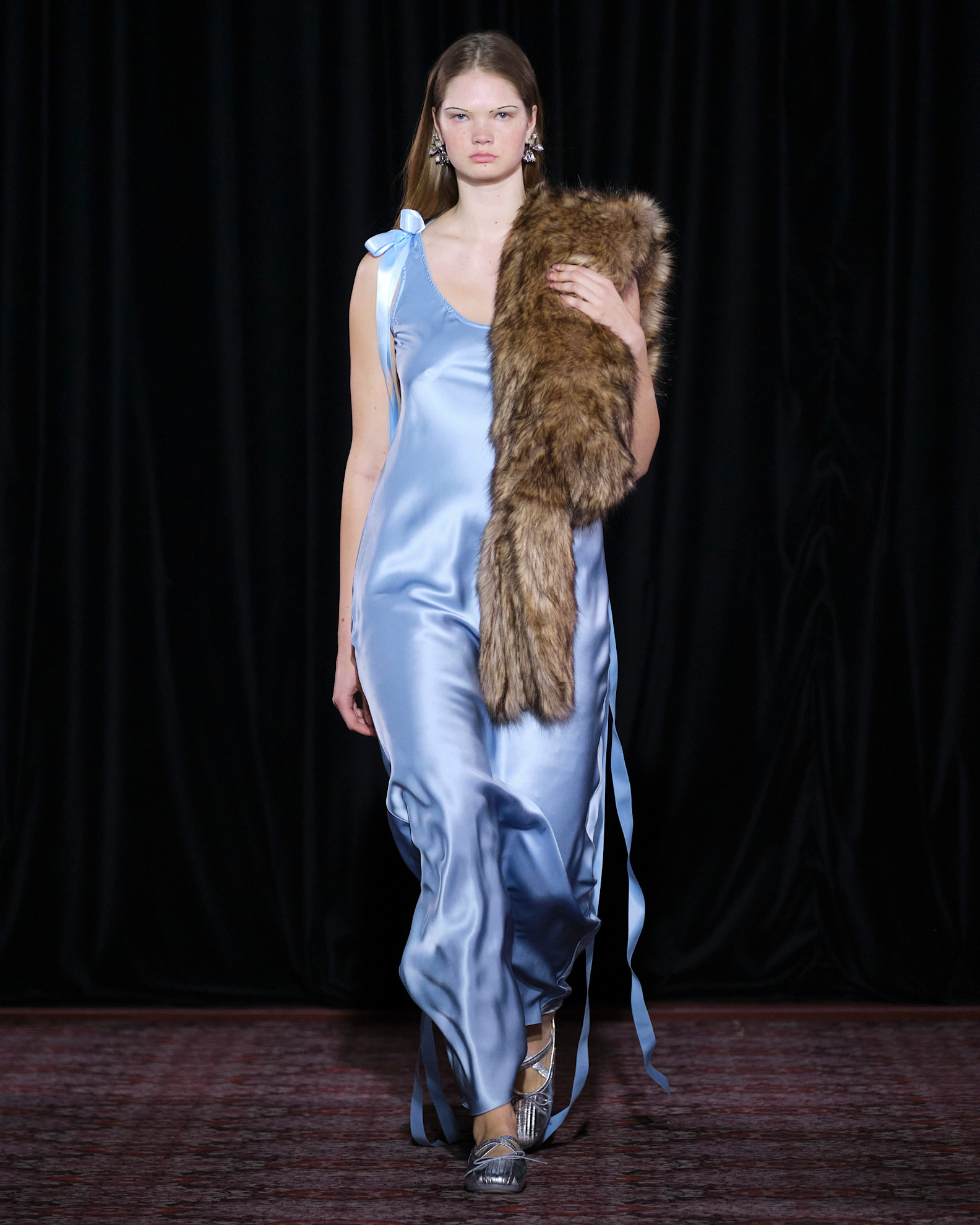 Model wears the baby blue color trend on the runway.