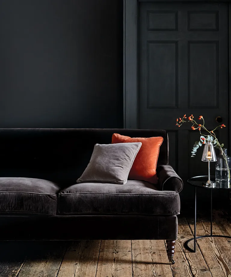 Black living room with velvet sofa