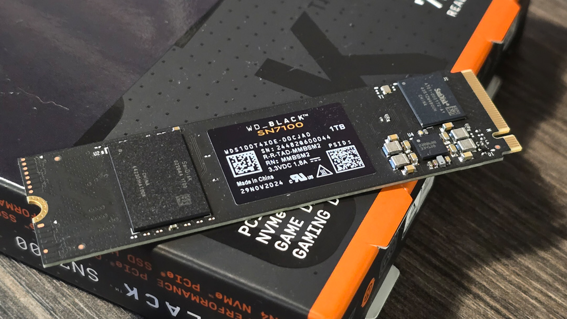 Close-up of a WD Black SN770 SSD resting on its packaging. The sleek black design and visible circuit components highlight its advanced technology.