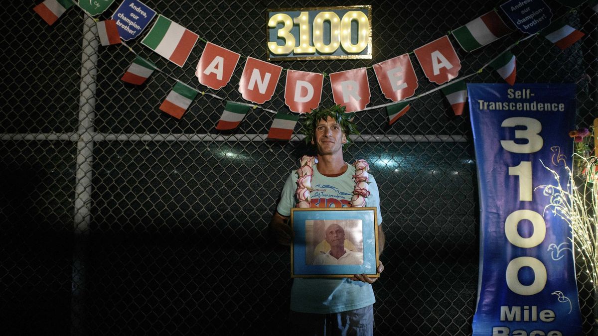 Andrea Marcato of Italy poses for a photo while holding a portrait of Indian spiritual personality Sri Chinmoy after winning the &#039;Self-Transcendence 