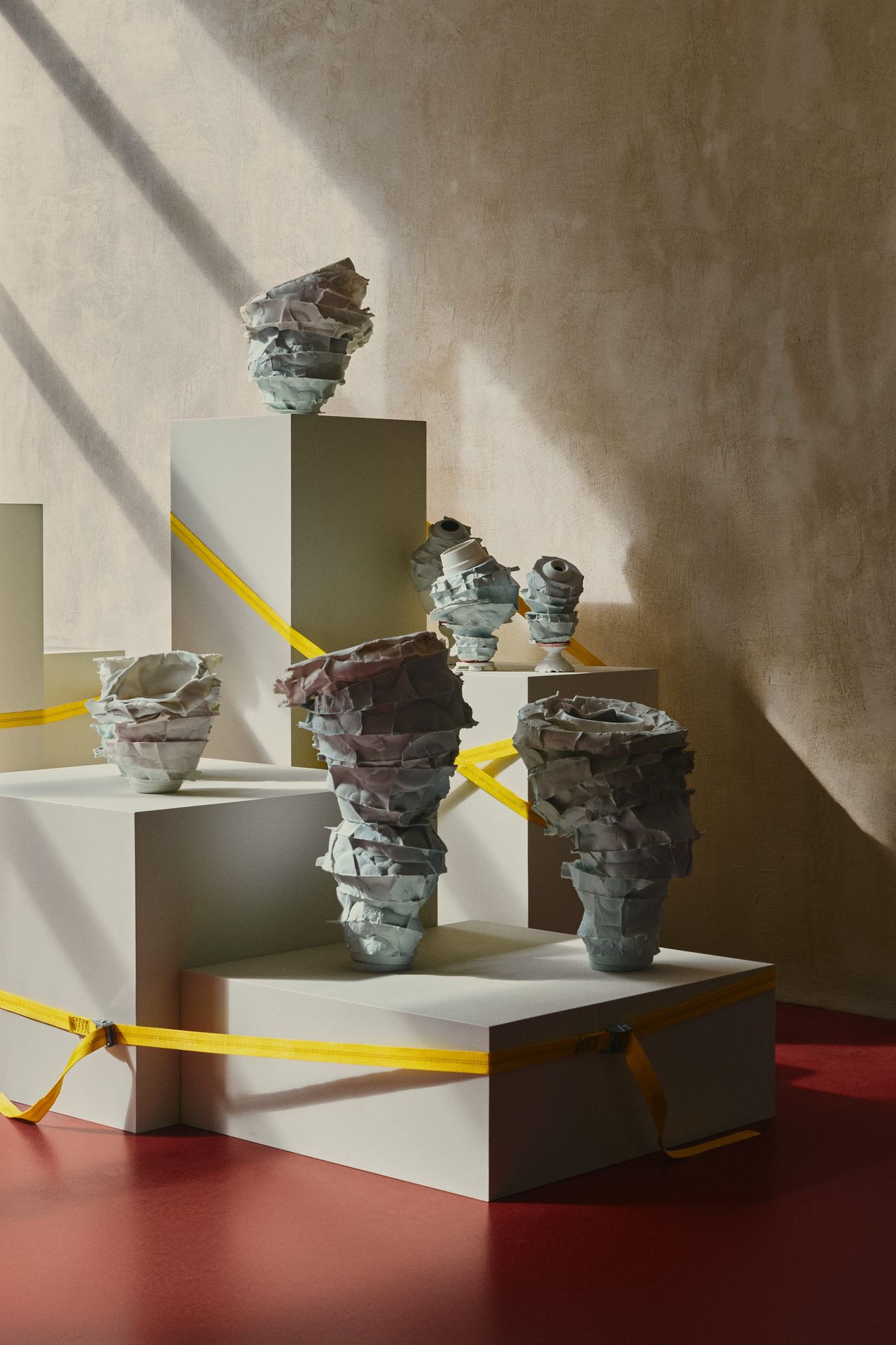 ceramic vessels arranged across plinths