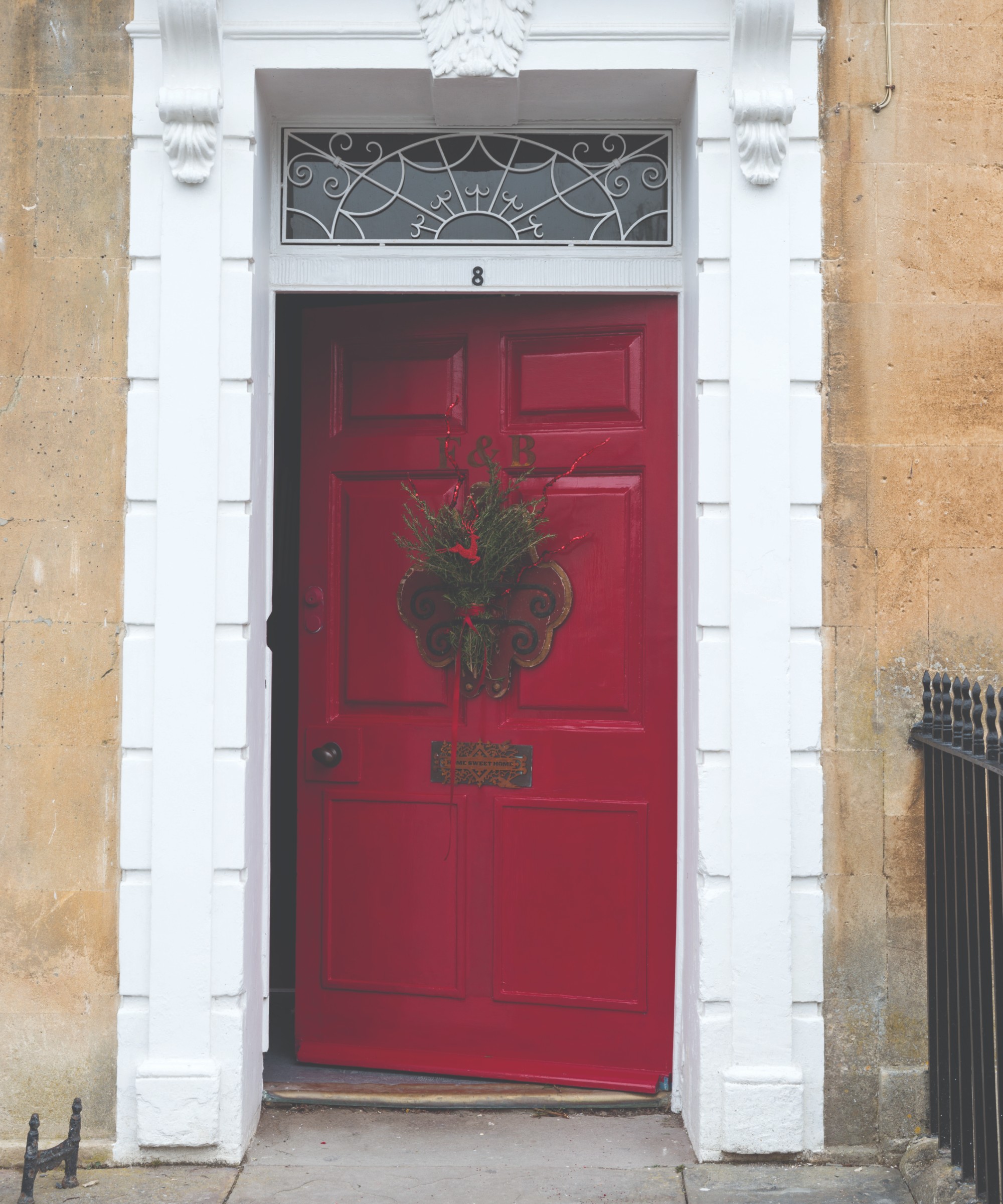 A red front door painted in Farrow &amp;amp; Ball's Incarnadine paint shade