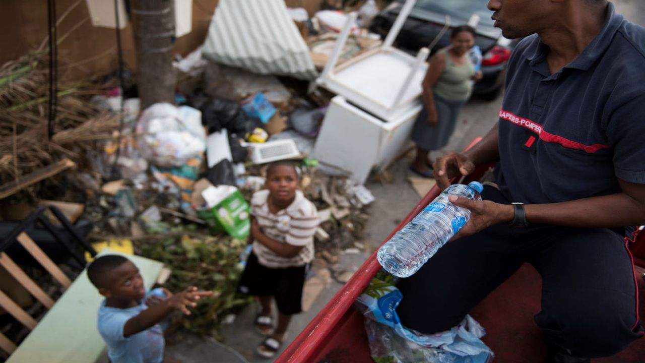 French aid workers hand out water on the island of St Martin