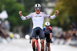 Niklas Behrens of Team Germany celebrates at finish line as gold medal winner in men's U23 road race at 2024 Road World Championships