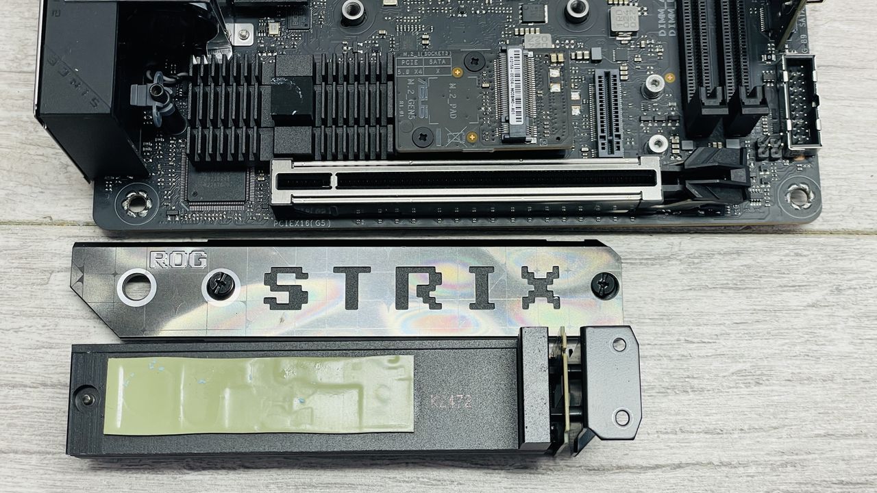 Asus ROG Strix X870-I Gaming WiFi motherboard on a desk.