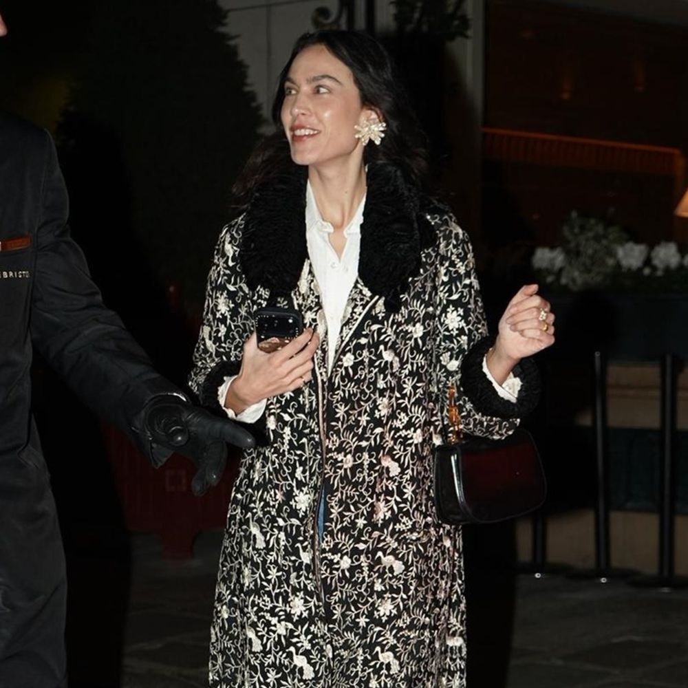 Alexa Chung wears an ornate jacket with straight-leg jeans, lilac heels and oversized earrings.