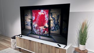 The Sony X95L on a TV stand, with an image showing a Japanese house