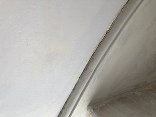 Caulk removed from round the baseboard of the stairs
