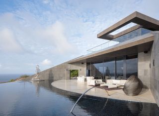 Outside of residence with seating area and infinity pool