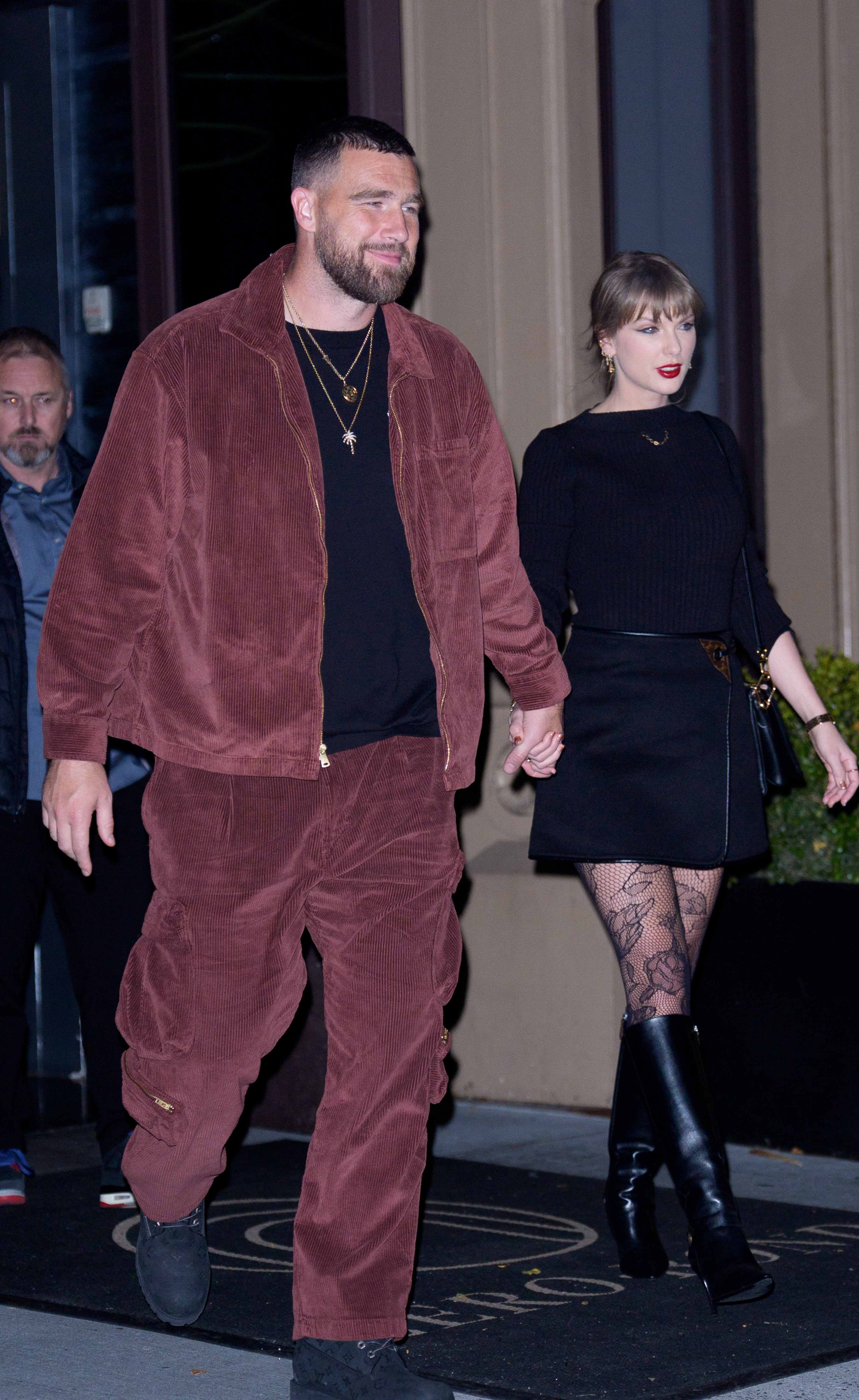 Taylor Swift and Travis Kelce leaving a restaurant