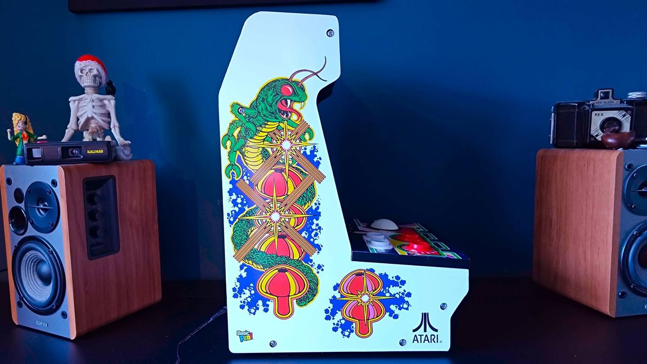 Side view of Arcade Classics Centipede machine artwork with motif on white backdrop.