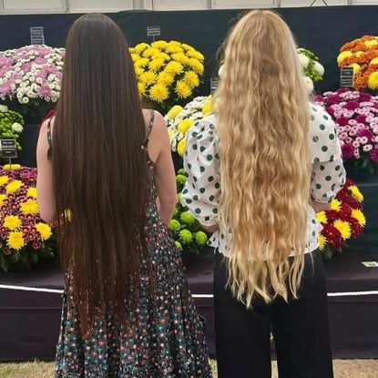 Daisy Hoppen and Hannah Weiland with their backs to the camera showing off their mermaid hair