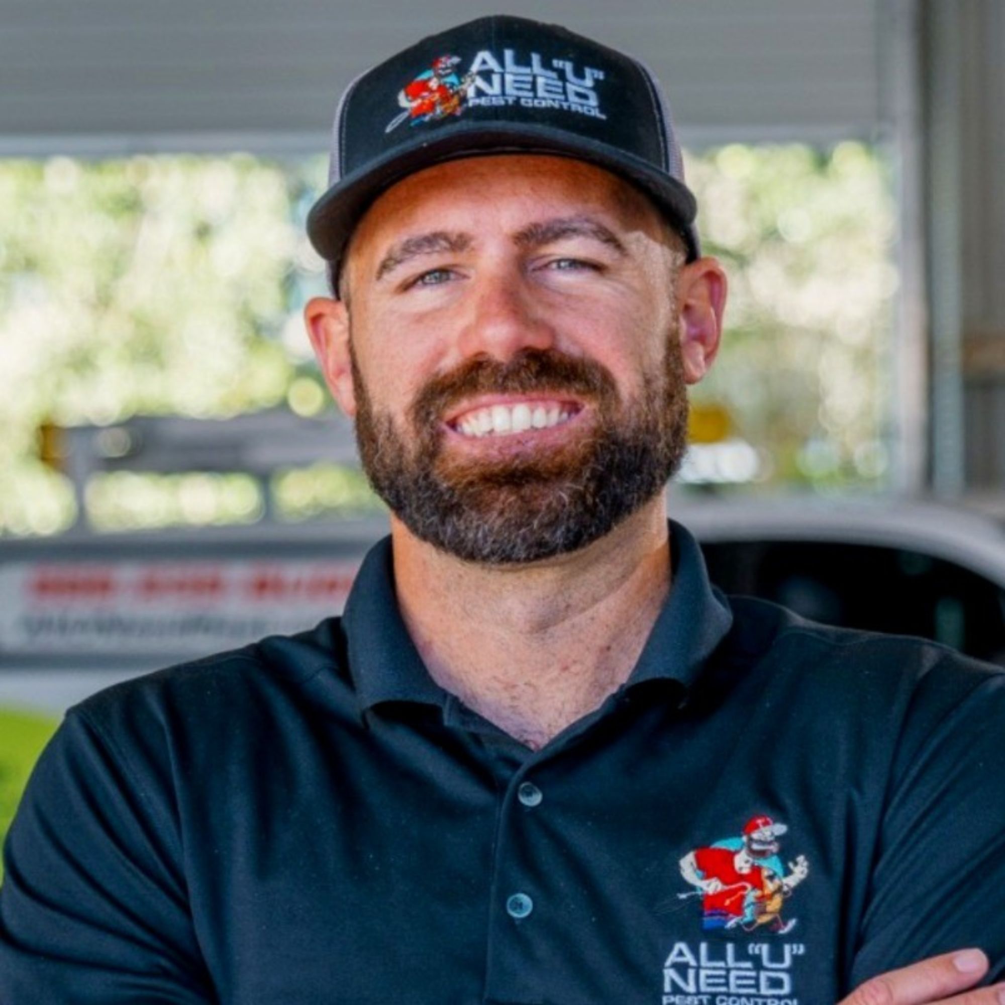 Pest control specialist wearing navy cap