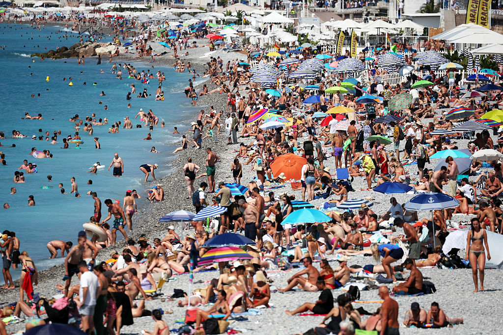 Tourists enjoy the beach along the "Promenade des Anglais" on the French riviera city of Nice, on July 14, 2025.