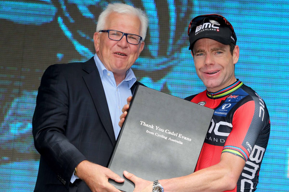 Cycling Australia president Malcolm Speed presents Cadel Evans with a book signed by fans