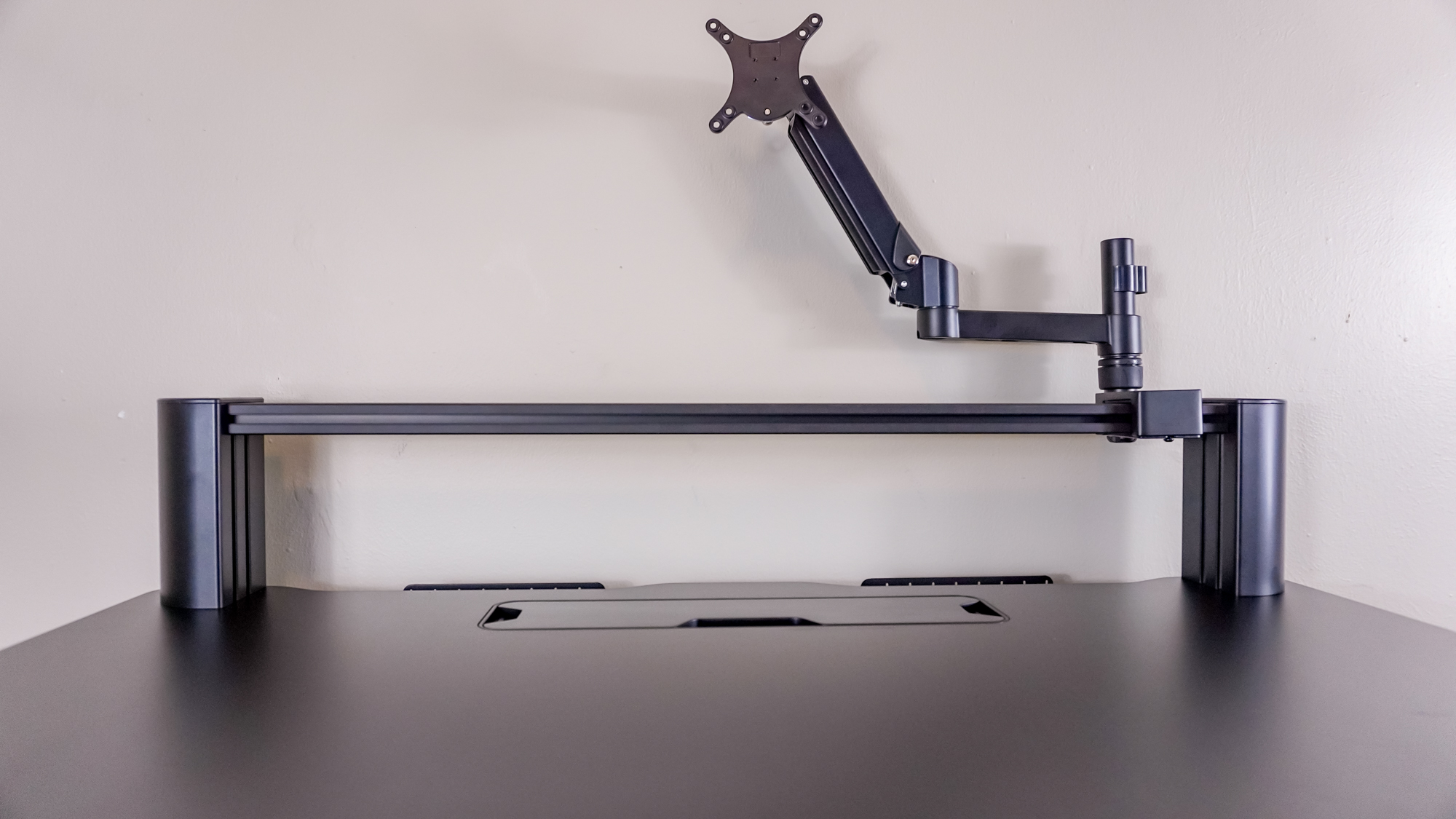 A close-up shot of the Corsair Platform 4: Elevate Desk's T-Channel rail system and its included monitor arm