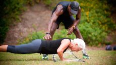 Senior woman being coached through push ups