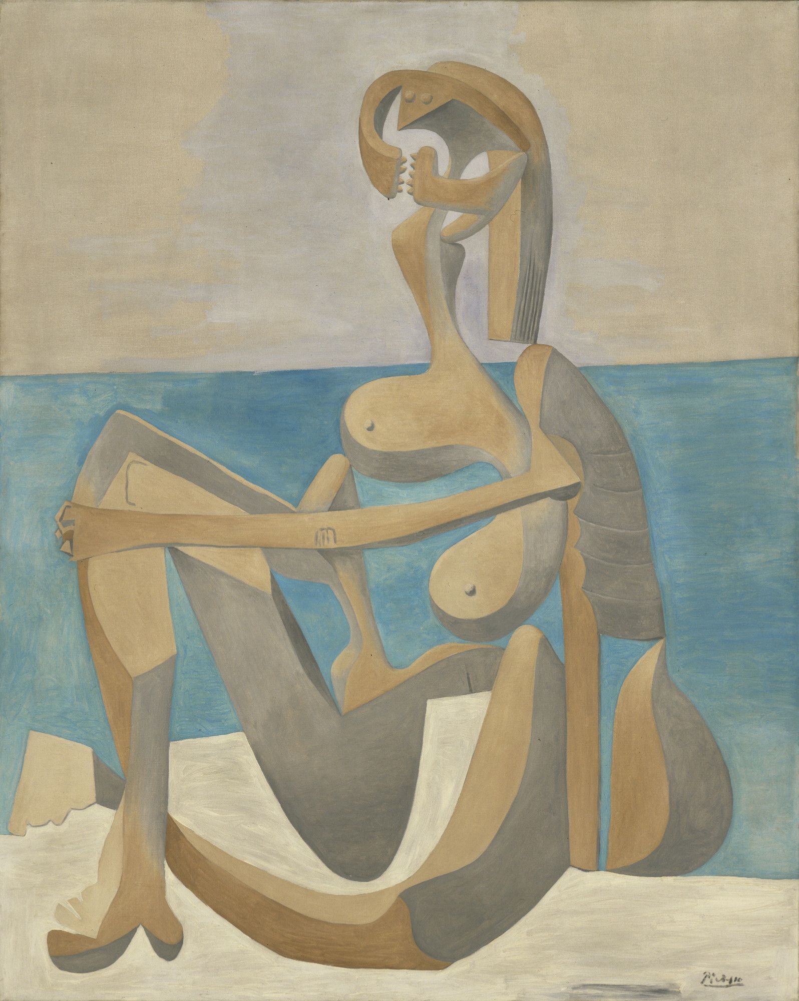 An abstract rendition of a female body, painted in pale yellow, beige, and blue as a fractured silhouette sitting on sand.
