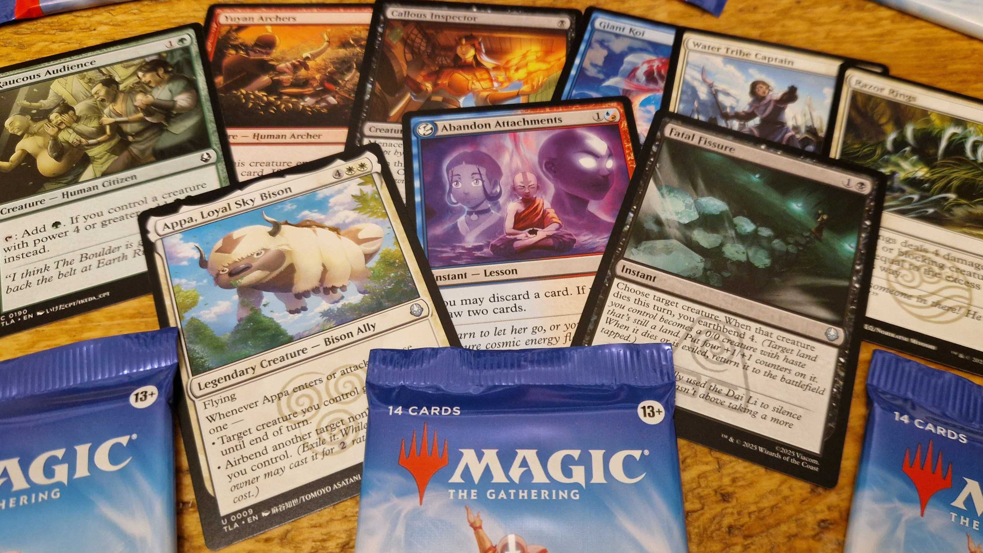 An array of MTG Avatar: The Last Airbender cards spread across a wooden surface