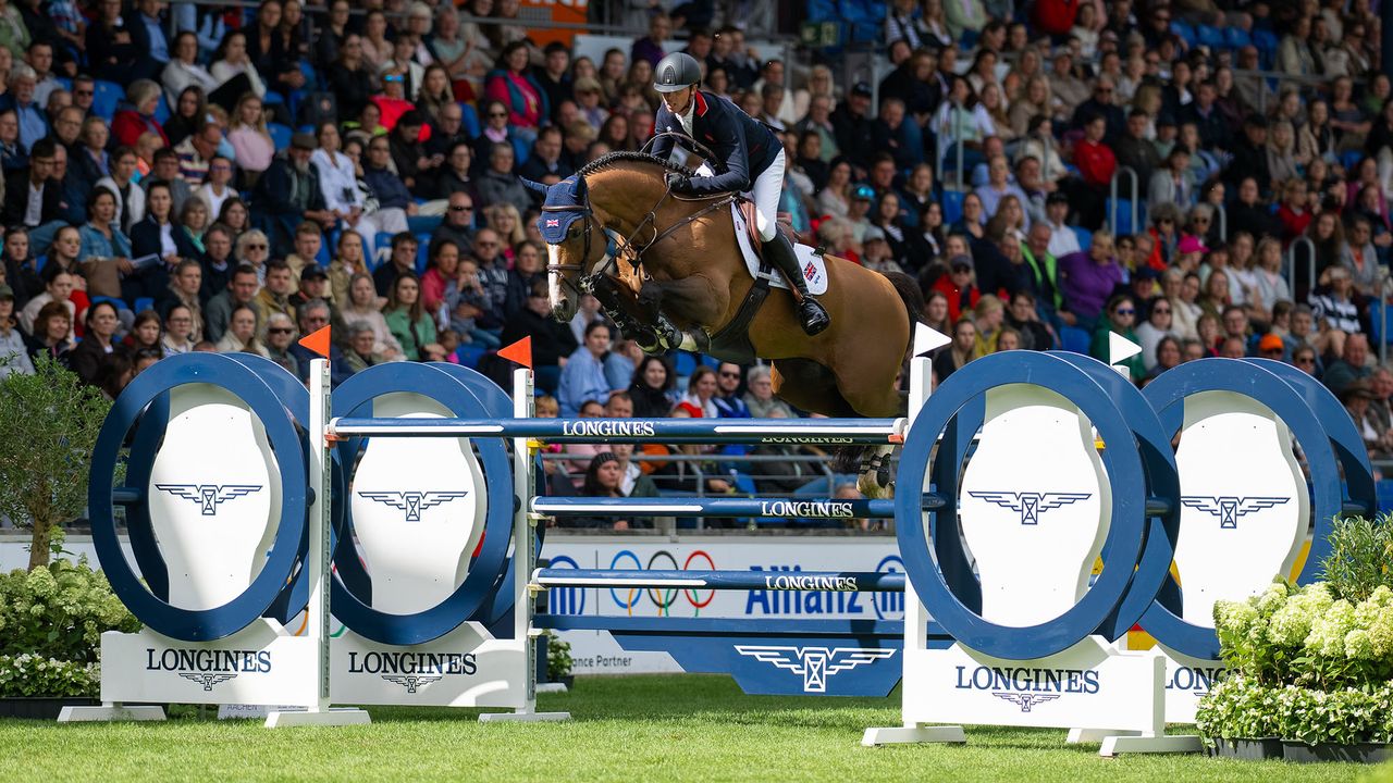 Ben Maher and Point Break clear a large navy and white oxer at the Aachen World Showjumping Championships
