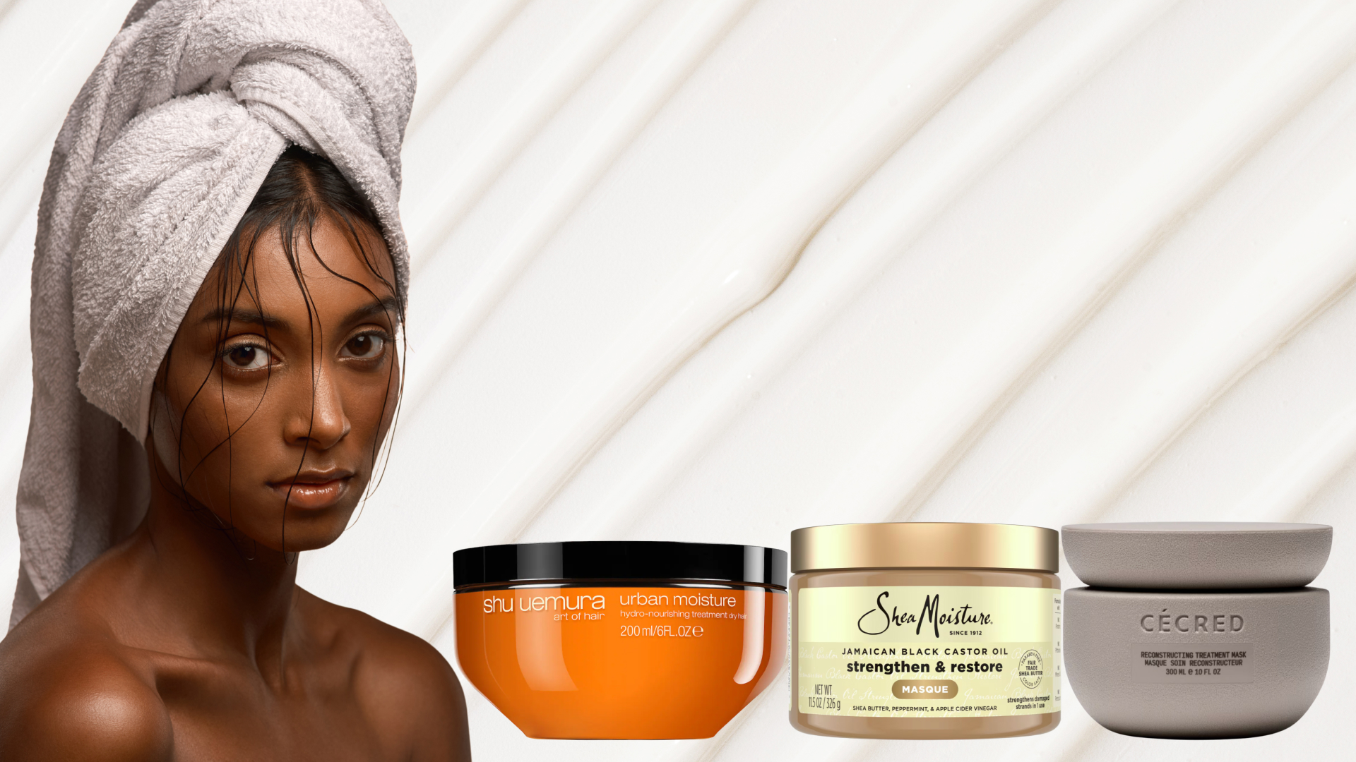 A woman with a towel on her head beside three tubs of hair masks for curly hair. 