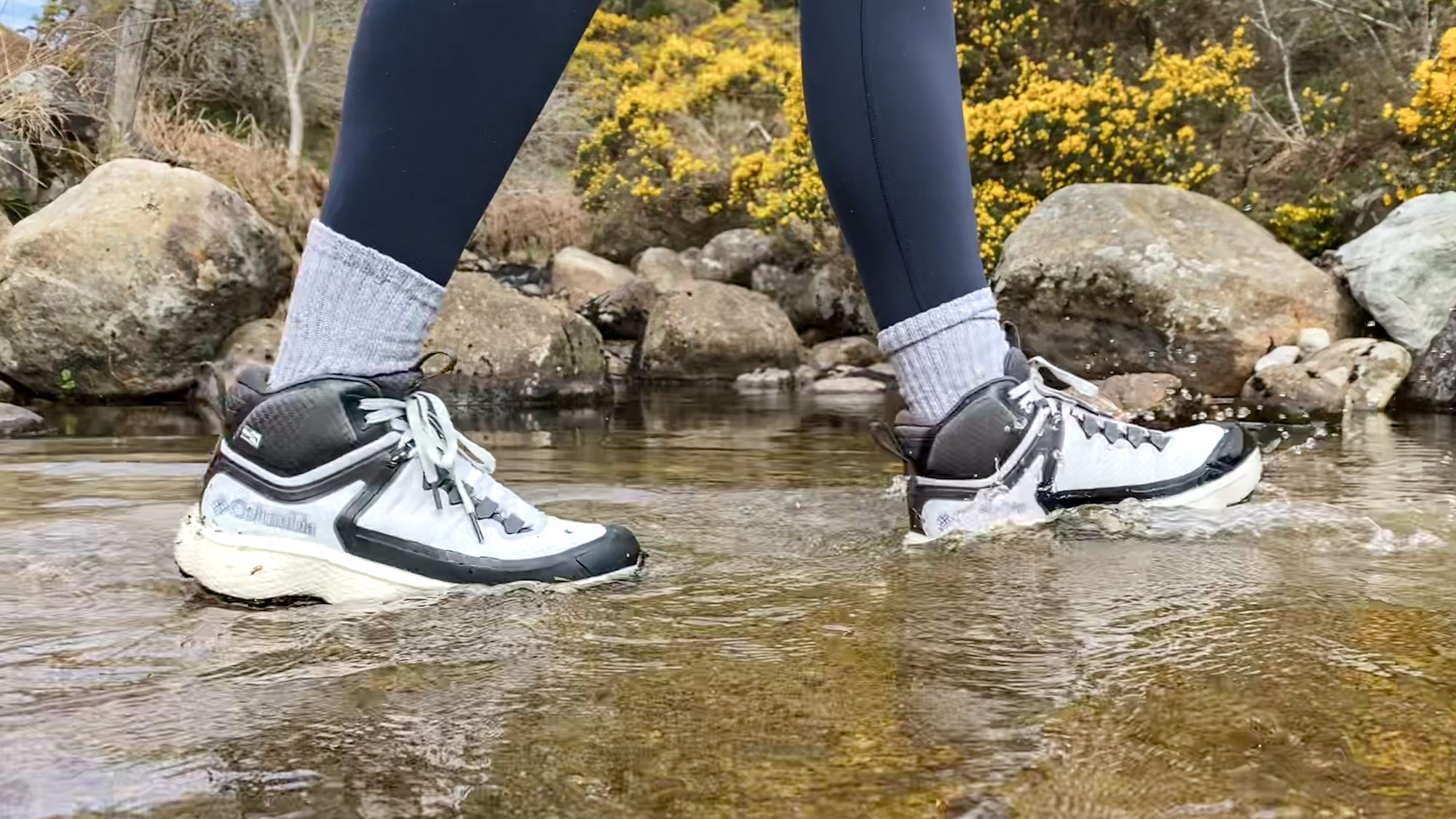 Tom's Guide writer Jessica walking through a stream wearing the Columbia Escape Thrive Titanium OutDry Mid Shoe