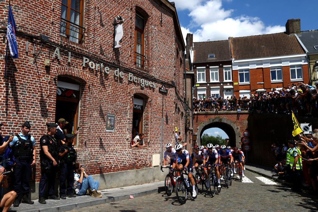 CALAIS FRANCE JULY 05 Andrea Bagioli of Italy and QuickStep Alpha Vinyl Team leads the peloton passing through the Cte de Cassel Village while fans cheer during the 109th Tour de France 2022 Stage 4 a 1715km stage from Dunkerque to Calais TDF2022 WorldTour on July 05 2022 in Calais France Photo by Michael SteeleGetty Images