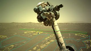 A robotic arm is seen in the foreground. In the background is the barren land of Mars with manually drawn lines to denote different areas.
